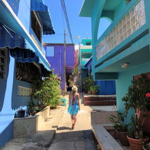 Anna walking down a brightly colored pedestrian street in Puerto Rico after her relocation