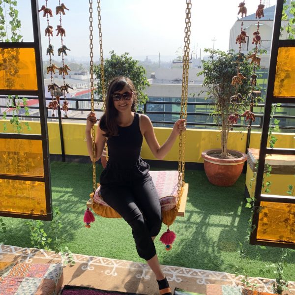 Leikyn on a swingset at the hotel in New Delhi, India, on her long-term travel journey