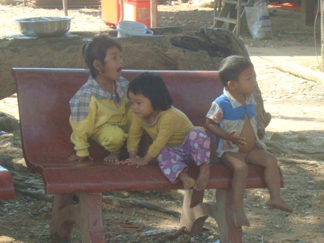 A photo of small kids playing on a bench in Kompong Phluk