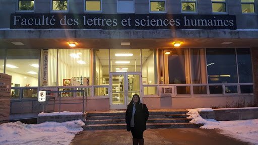A photo of Alexandra in front of her college building during her study exchange in Canada.