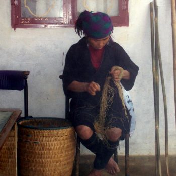 A woman weaving a basket, one of the many reasons to visit Sa Pa