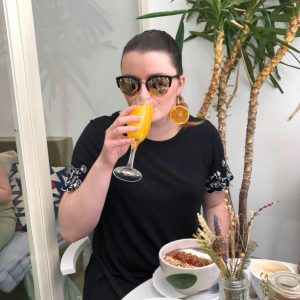 Emma drinking a mimosa from Madrid