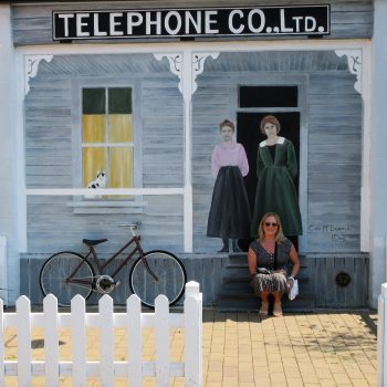 Ed's wife in front of the old telephone company building in Chemaimus.