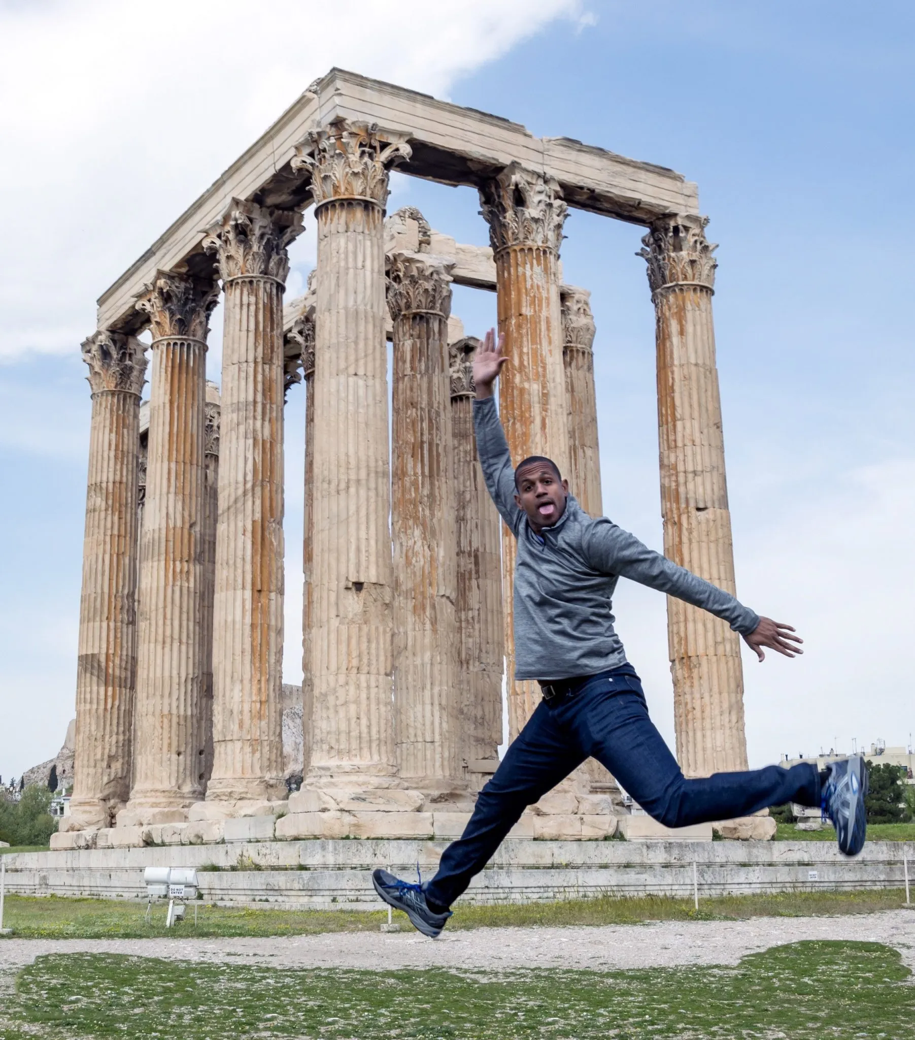 Guy Guyton in front of ancient Greek architecture while traveling abroad