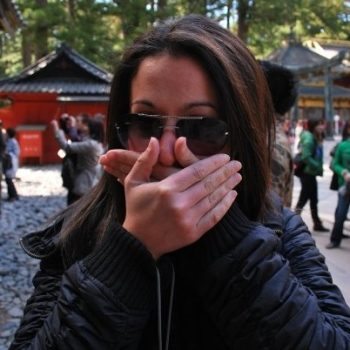Maria, an English teacher in Japan, replicating the speak no evil sign