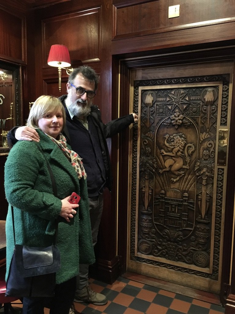 Jim Murty and his wife in front of a Ballymoney door in Northern Ireland