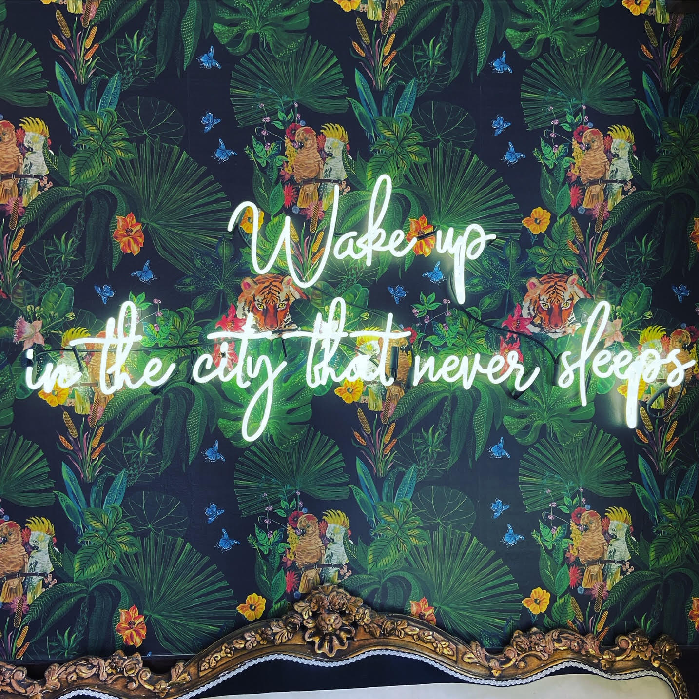 Wallpaper with LED lights that say "Wake up in the city that never sleeps"