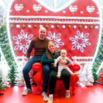 Kristen and her family posing at a Christmas display in Strasbourg