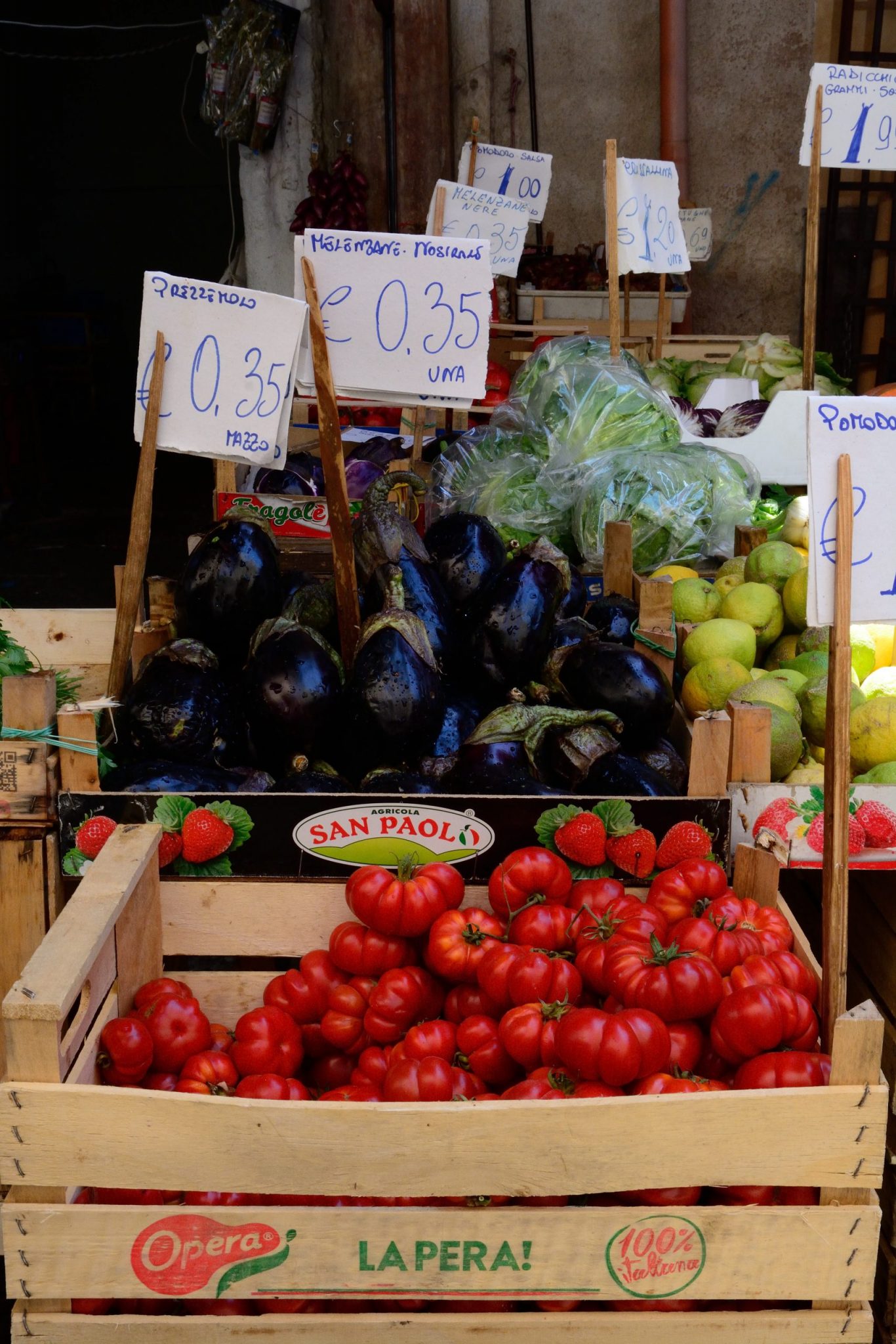 a photo of eggplants and tomatoes for sale in Italy