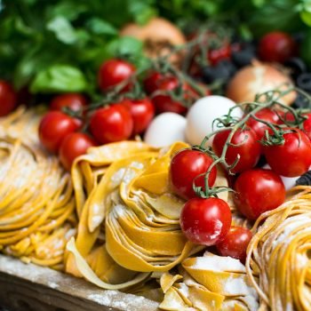 A photo of homemade pasta, mozzarella, and tomatoes