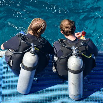 Photo by Laya Clode. Two friends with scuba gear in Tenerife.